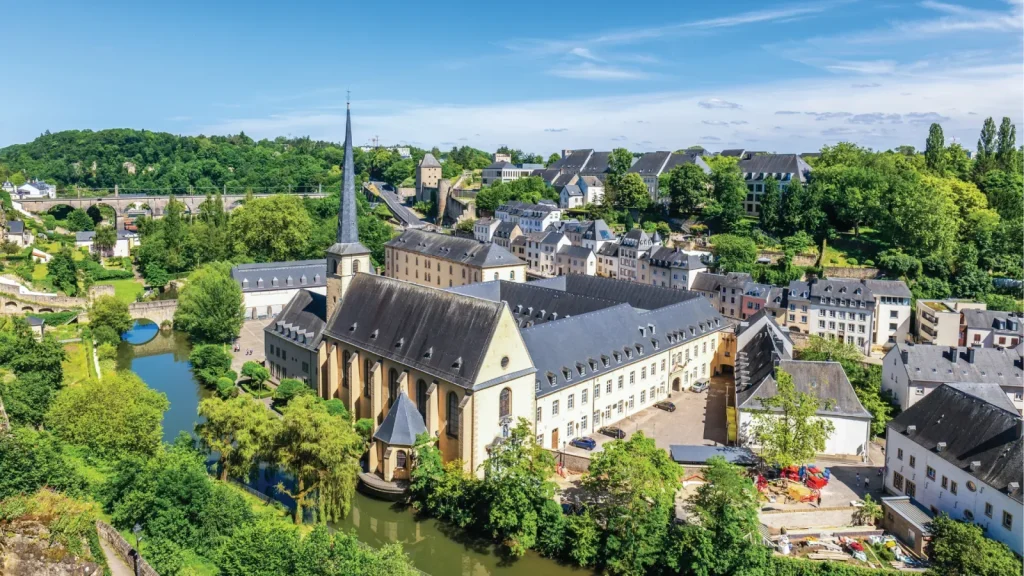 Luxembourg City: the Grund with the Neumünster abbey and the Alzette, under a blue sky