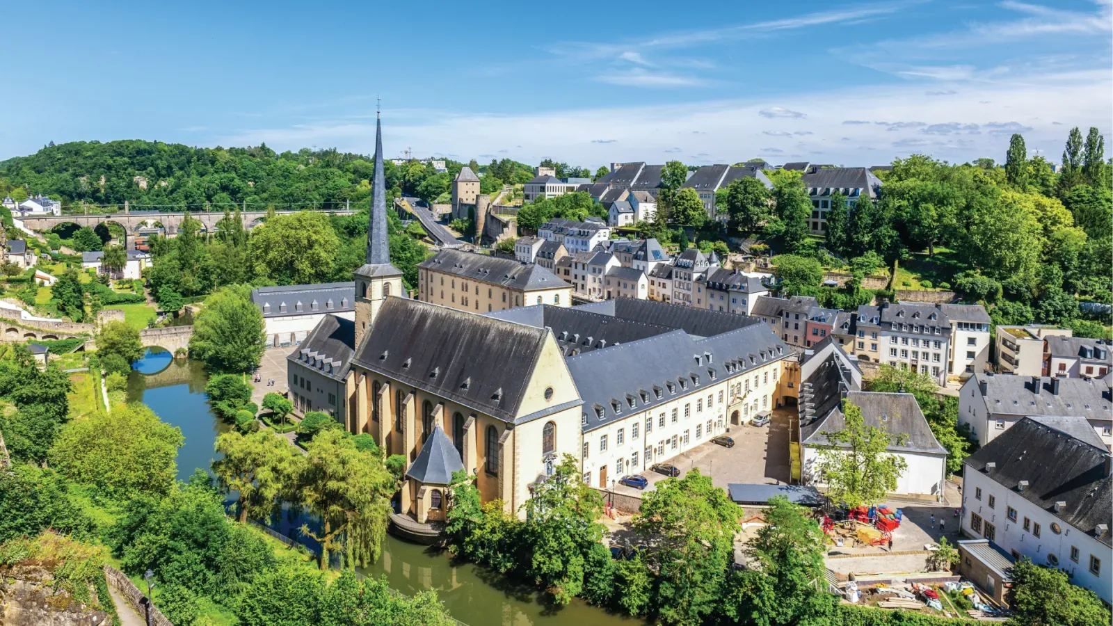 Luxembourg City: the Grund with the Neumünster abbey and the Alzette, under a blue sky